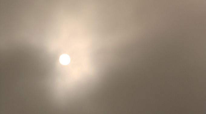 sun breaking through the fog, sepia